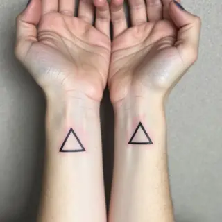Minimalist Triangle Tattoos: A Study in Symmetry and Meaning