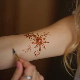 Delicate Henna: Tiny Arm Tattoos for Subtle Style