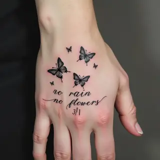 Delicate Butterfly and Script Tattoos on Hand